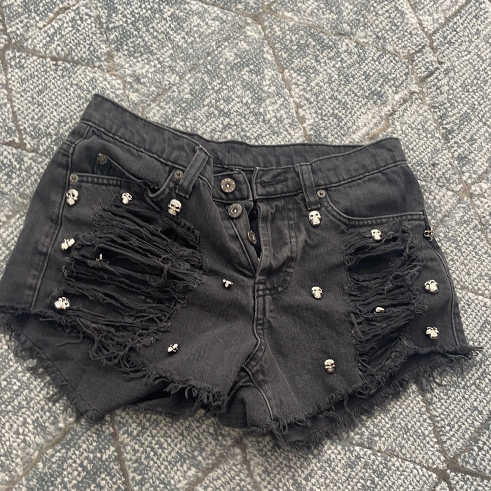 Black distressed denim shorts with skull buttons